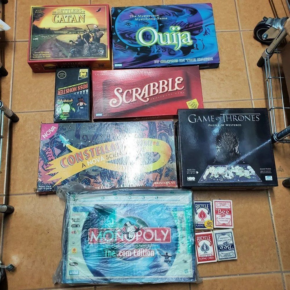 5x Board Games, 1x puzzle, 1x deck builder game, 4x packs of playing cards